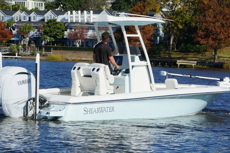 Slide: The Image of 2022 ShearWater 250 XTE boat on a scenic lake with Yamaha engine. - 6