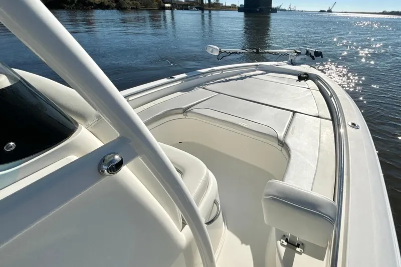 Slide: The Image of 2022 ShearWater 250 XTE boat on calm water, showcasing sleek design and spacious deck. - 8