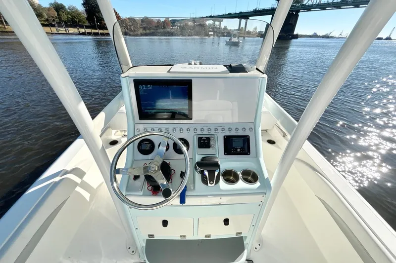 Slide: The Image of 2022 ShearWater 250 XTE boat dashboard with steering wheel and navigation system. - 9