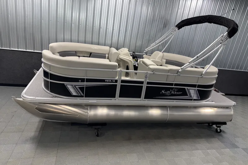 Slide: The Image of 2026 SunChaser Vista 18 LR pontoon boat in showroom, featuring sleek design and comfortable seating. - 0