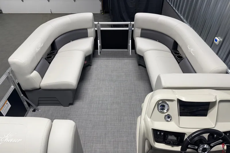 Slide: The Image of 2026 SunChaser Vista 18 LR pontoon boat interior with plush seating and modern dashboard. - 13