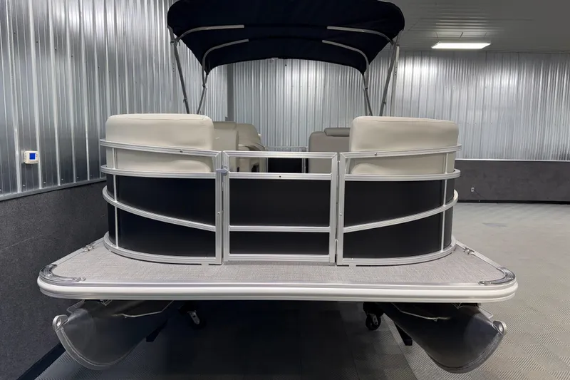 Slide: The Image of 2026 SunChaser Vista 18 LR pontoon boat in a metal-walled showroom. - 17