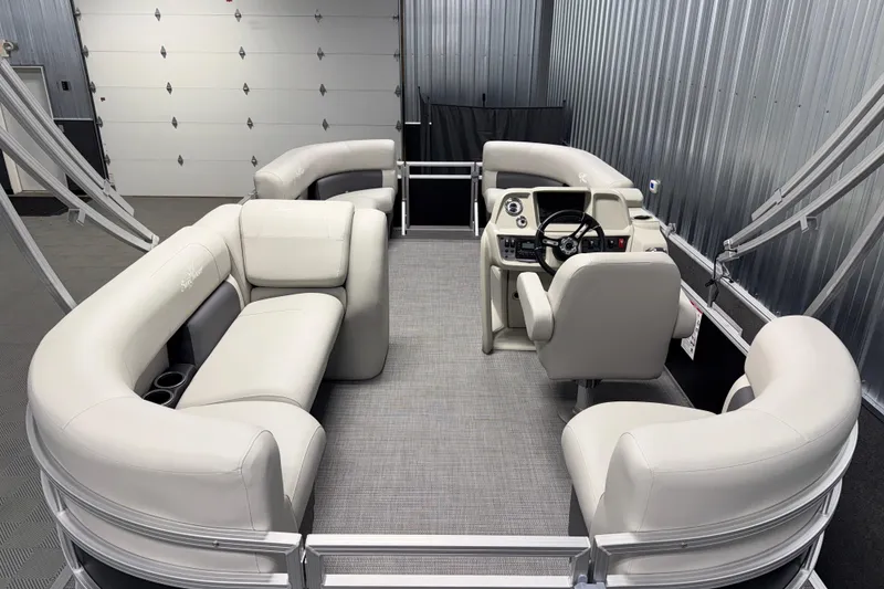 Slide: The Image of 2026 SunChaser Vista 18 LR pontoon boat interior with plush seating and modern helm. - 2