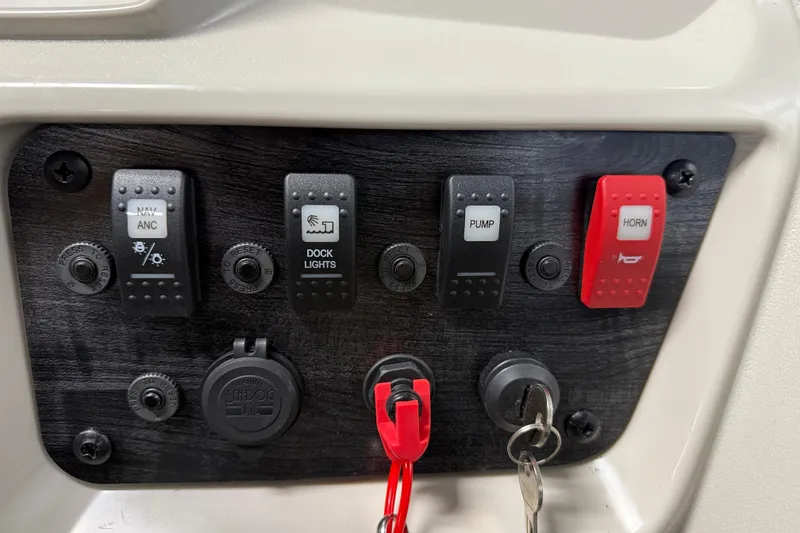 Slide: The Image of Control panel of 2026 SunChaser Vista 18 LR boat with switches and key ignition. - 9