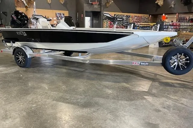 The Image of 2026 Excel EX 183 boat on trailer in showroom, black and white design. - 0