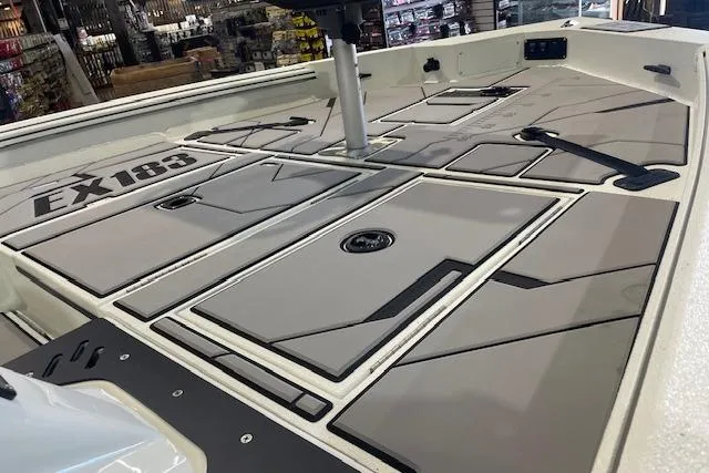 Slide: The Image of 2026 Excel EX 183 boat deck with storage compartments and sleek design. - 10