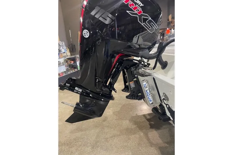 Slide: The Image of 2026 Excel EX 183 boat motor, black with red accents, displayed indoors. - 2