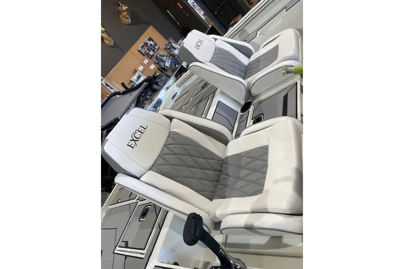 Slide: The Image of 2026 Excel EX 183 boat seats with white and gray diamond pattern upholstery. - 5