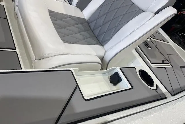 Slide: The Image of 2026 Excel EX 183 boat interior with gray and white seating, cup holder, and storage compartment. - 6