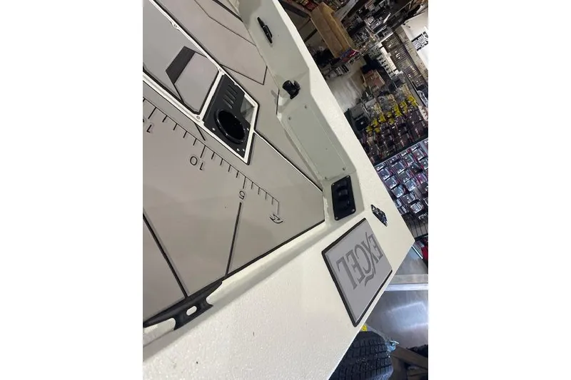 Slide: The Image of 2026 Excel EX 183 boat interior with measurement markings and control panel. - 9
