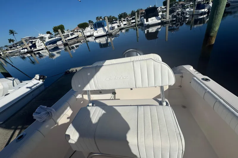 Slide: The Image of 2007 Cobia 237 Center Console boat docked at marina with calm water. - 11