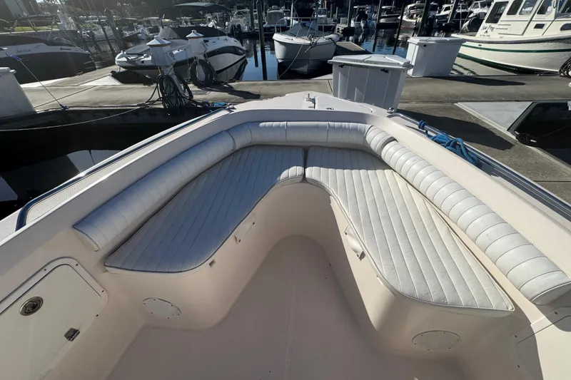 Slide: The Image of 2007 Cobia 237 Center Console boat with cushioned seating at marina. - 13