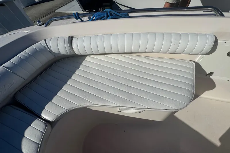 Slide: The Image of 2007 Cobia 237 Center Console boat with white cushioned seating. - 15