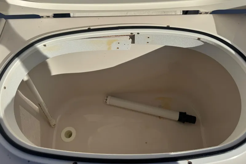 Slide: The Image of Open storage compartment in 2007 Cobia 237 Center Console boat. - 17