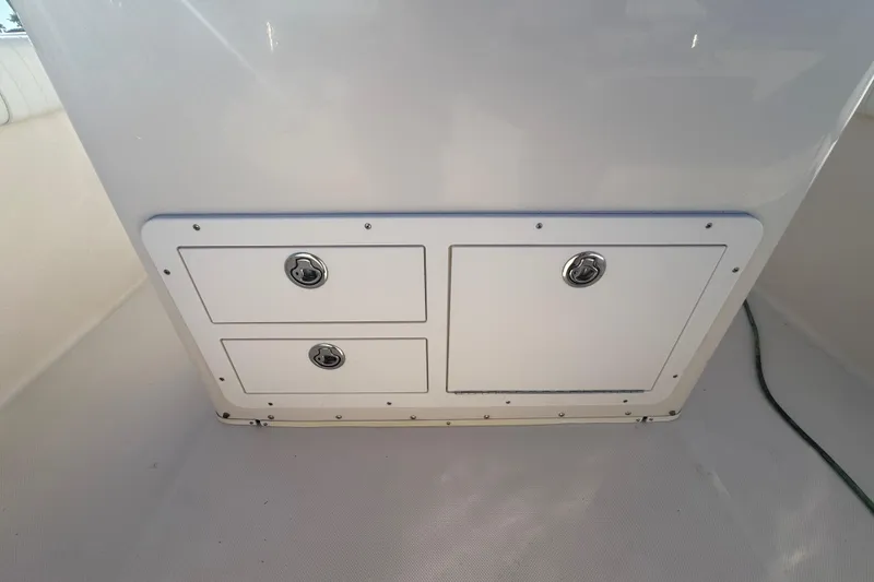 Slide: The Image of Storage compartment on a 2007 Cobia 237 Center Console boat interior. - 18