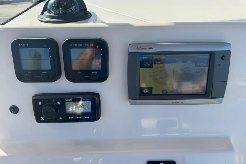 Slide: The Image of 2007 Cobia 237 Center Console dashboard with Garmin GPS, tachometer, and speed fuel gauges. - 6