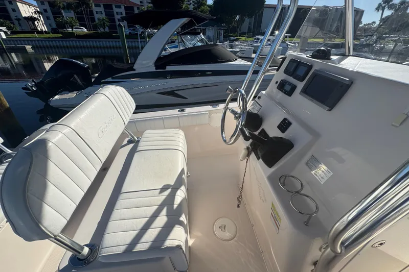 Slide: The Image of 2007 Cobia 237 Center Console boat interior with steering wheel and seating. - 8