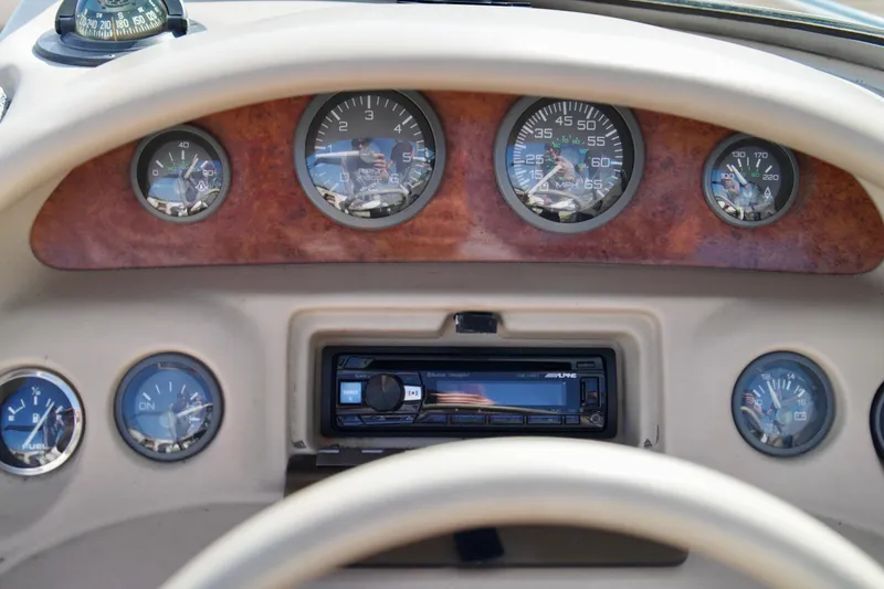 Slide: The Image of Dashboard of a 1995 Sea Ray 200 Bow Rider with gauges and stereo system. - 14