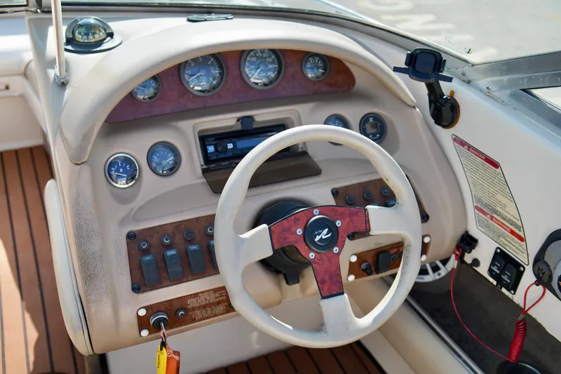 Slide: The Image of 1995 Sea Ray 200 Bow Rider dashboard with steering wheel and instrument panel. - 16