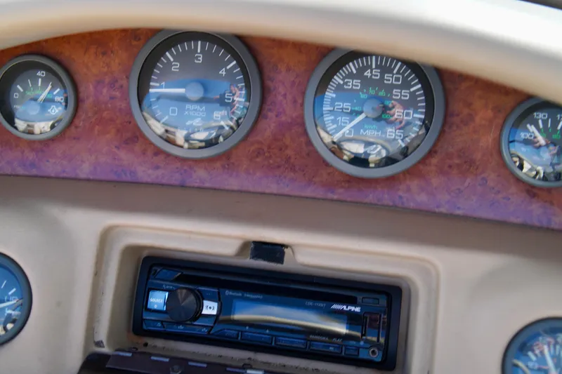 Slide: The Image of Dashboard of a 1995 Sea Ray 200 Bow Rider with gauges and stereo system. - 17
