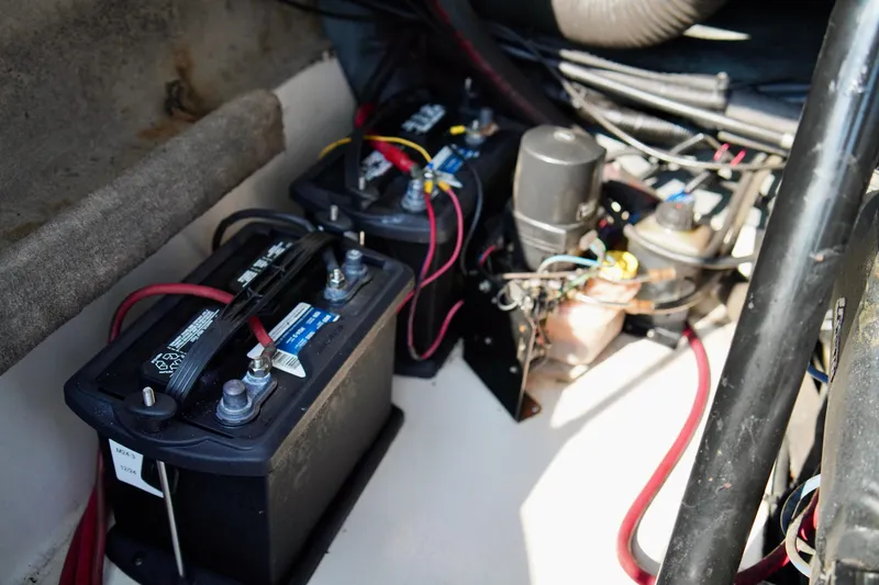 Slide: The Image of 1995 Sea Ray 200 Bow Rider battery compartment with wiring and components. - 27