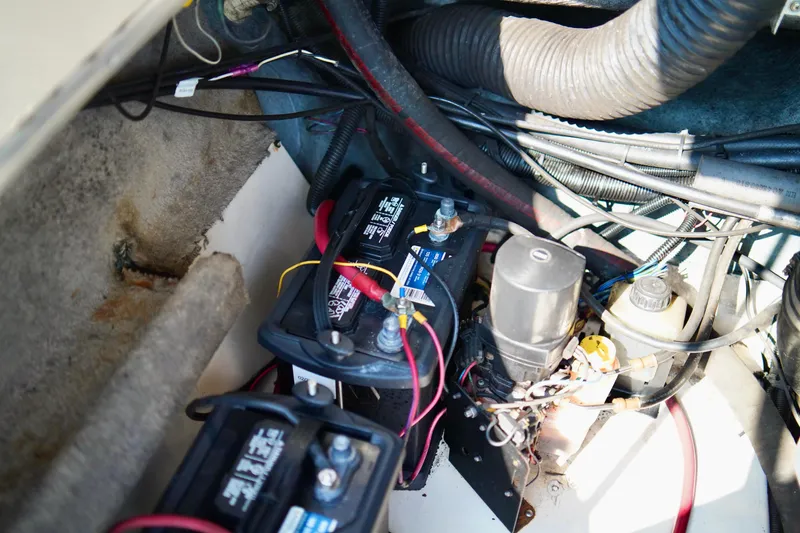 Slide: The Image of Engine compartment of a 1995 Sea Ray 200 Bow Rider with visible batteries and wiring. - 28
