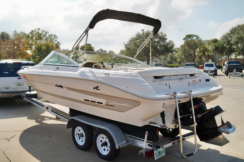 Slide: The Image of 1995 Sea Ray 200 Bow Rider boat on trailer, parked outdoors on a sunny day. - 31