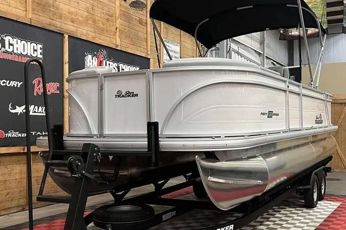 Slide: The Image of 2026 Sun Tracker Party Barge 22 RF DLX pontoon boat on display in showroom. - 10