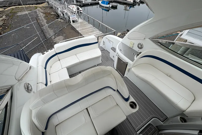 Slide: The Image of 2011 Formula 34 Performance Cruiser with spacious white seating and sleek design at a dock. - 11