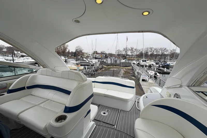 Slide: The Image of Interior view of 2011 Formula 34 Performance Cruiser at marina, featuring white seating. - 12