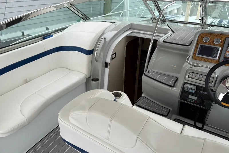 Slide: The Image of 2011 Formula 34 Performance Cruiser cockpit with white seating and modern dashboard controls. - 19