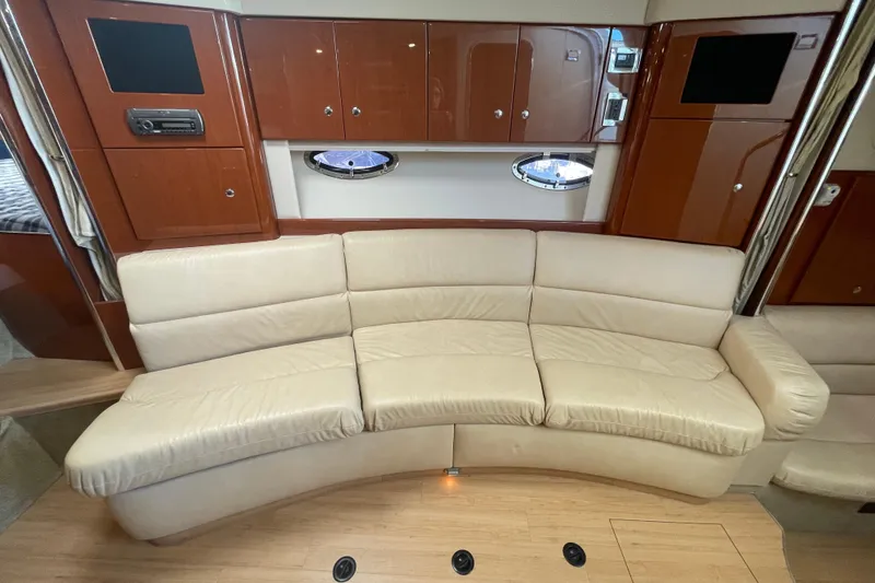 Slide: The Image of 2011 Formula 34 Performance Cruiser interior with beige leather sofa and wooden cabinetry. - 34