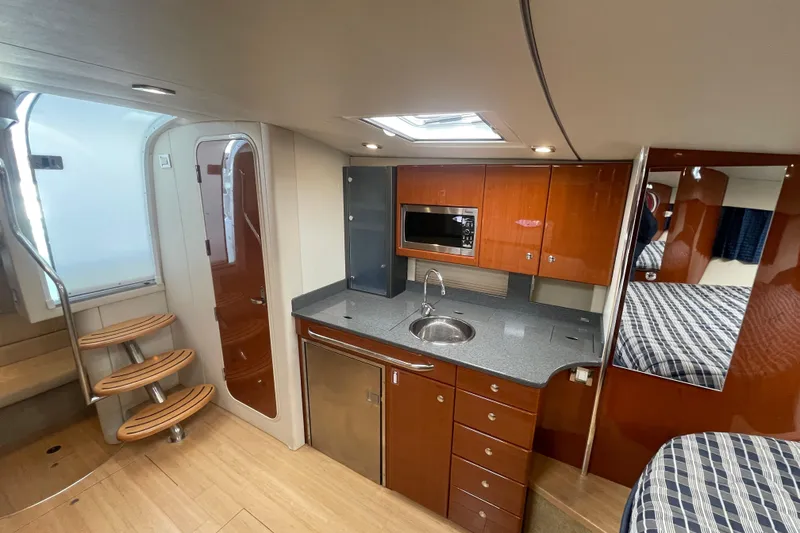 Slide: The Image of Interior of 2011 Formula 34 Performance Cruiser with modern kitchen and wooden cabinetry. - 35