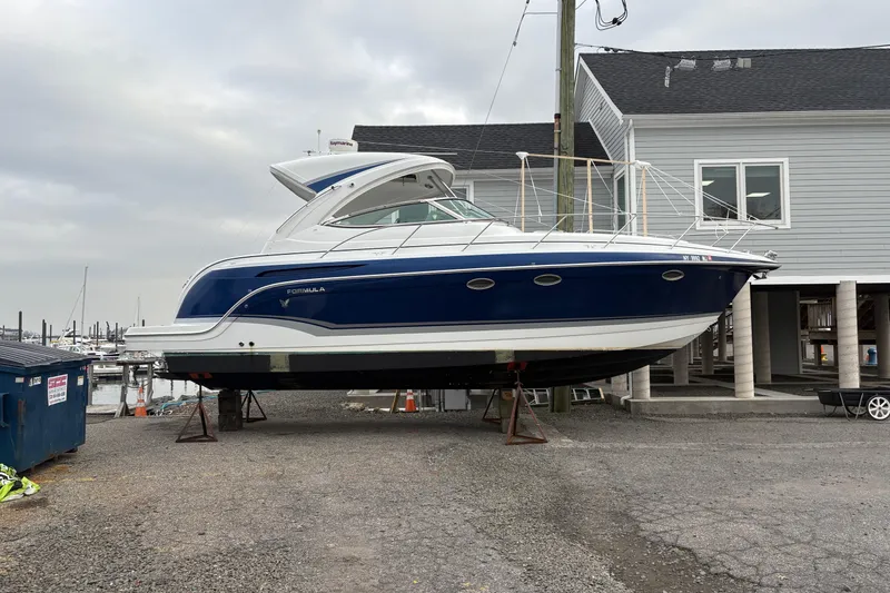 Slide: The Image of 2011 Formula 34 Performance Cruiser on stands at marina, overcast sky. - 4