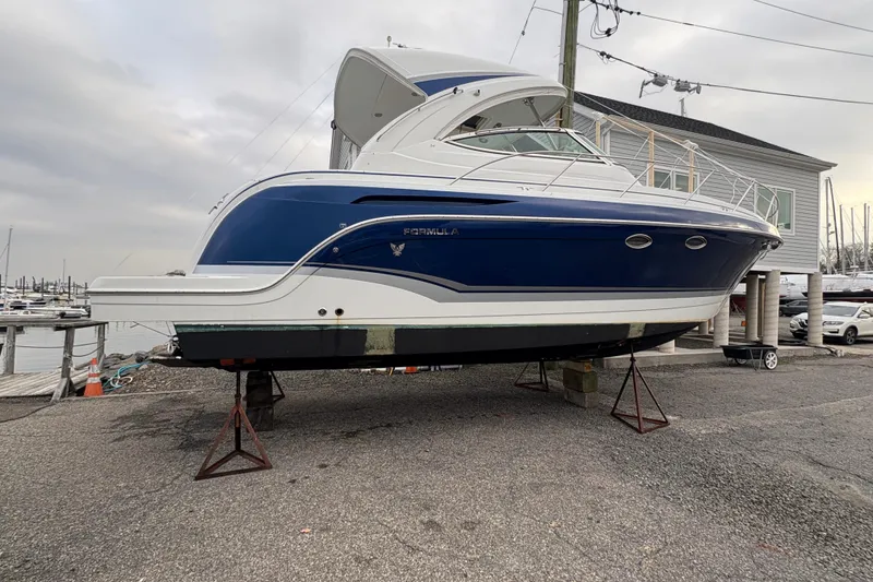 Slide: The Image of 2011 Formula 34 Performance Cruiser on dry dock, blue and white exterior. - 5