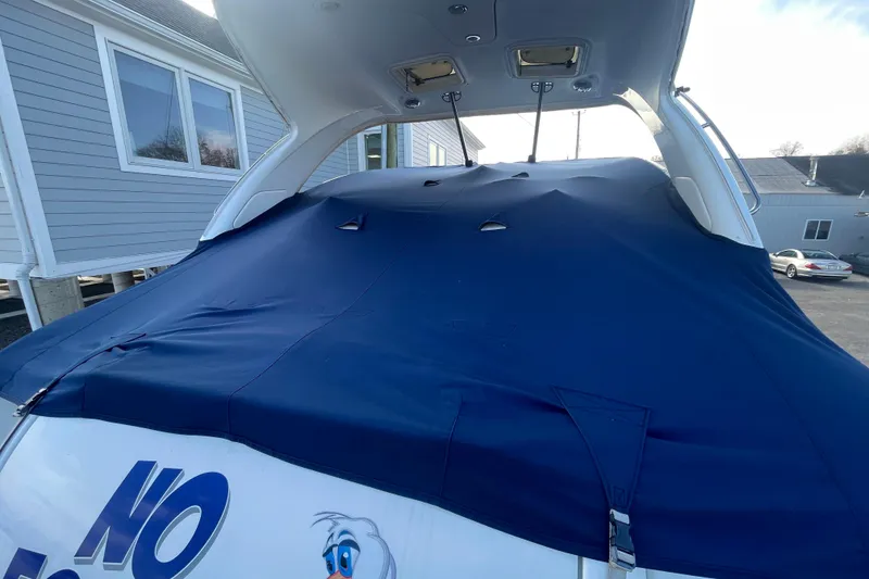 Slide: The Image of 2011 Formula 34 Performance Cruiser with blue cover, docked near residential buildings. - 7