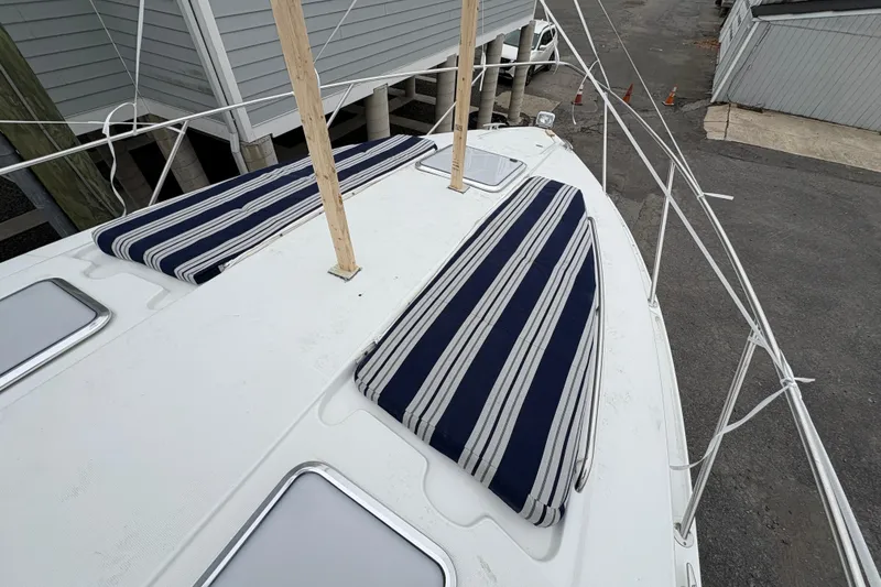 Slide: The Image of 2011 Formula 34 Performance Cruiser with striped deck cushions, docked near buildings. - 9