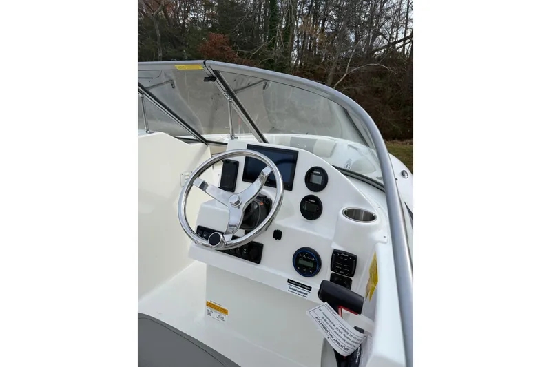 Slide: The Image of 2026 Key West 203 DFS boat docked near a serene waterfront. - 4