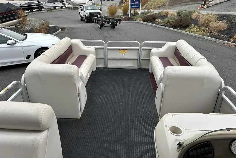 Slide: The Image of 2003 Sweetwater 2221 SC pontoon boat interior with white and maroon seating. - 9