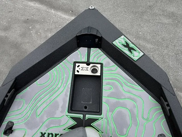 Slide: The Image of 2023 Xpress Boats X19 PRO bow with green contour design and logo detailing. - 10