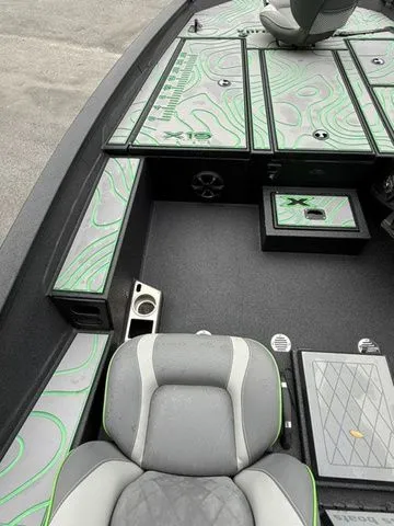 Slide: The Image of 2023 Xpress Boats X19 PRO interior with stylish seating and storage compartments. - 7