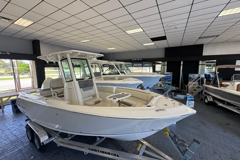 The Image of 2026 Sailfish 232 CC boat displayed indoors on a trailer. - 0