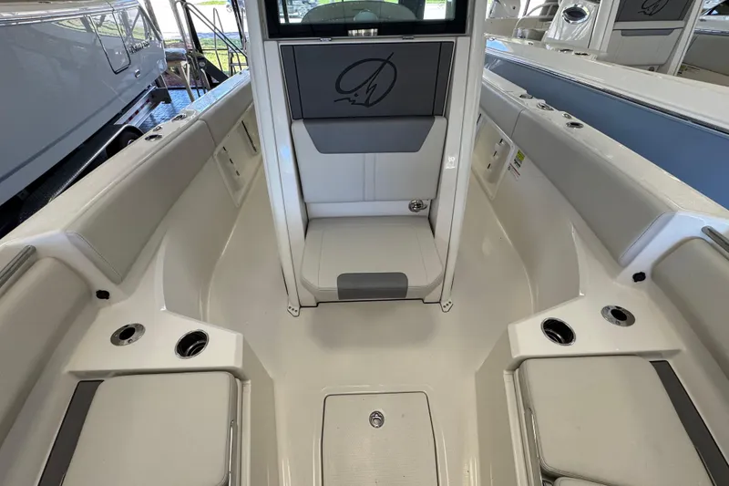 Slide: The Image of 2026 Sailfish 232 CC boat interior with seating and cup holders. - 11