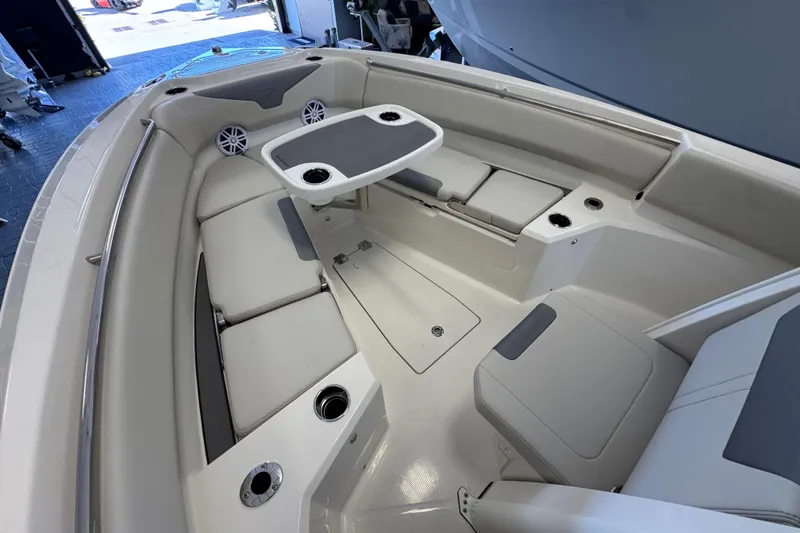 Slide: The Image of 2026 Sailfish 232 CC boat interior with seating and table in a showroom. - 12