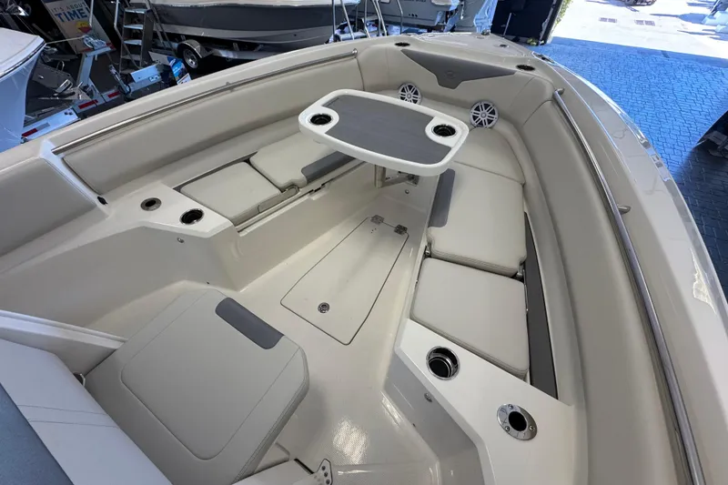 Slide: The Image of 2026 Sailfish 232 CC boat interior with seating and table in showroom. - 13