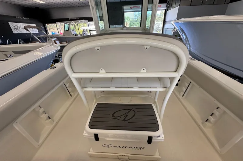 Slide: The Image of 2026 Sailfish 232 CC boat interior with seating and storage in showroom. - 4