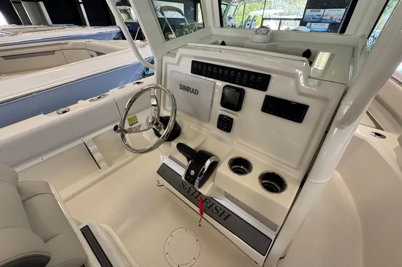 Slide: The Image of 2026 Sailfish 232 CC boat console with steering wheel and navigation controls. - 6