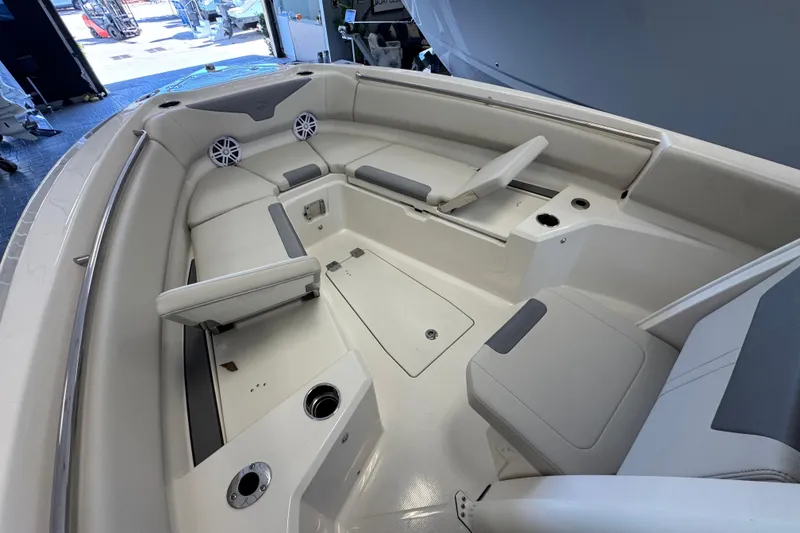 Slide: The Image of 2026 Sailfish 232 CC boat interior with cushioned seating and cup holders. - 9