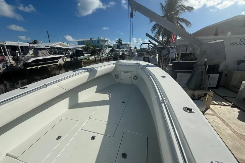 Slide: The Image of 2003 Contender 27 Open boat on calm blue water under clear sky. - 10