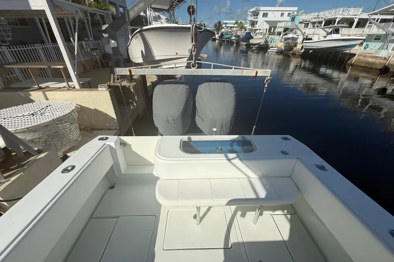 Slide: The Image of Storage compartment on a 2003 Contender 27 Open boat with red life jackets. - 21